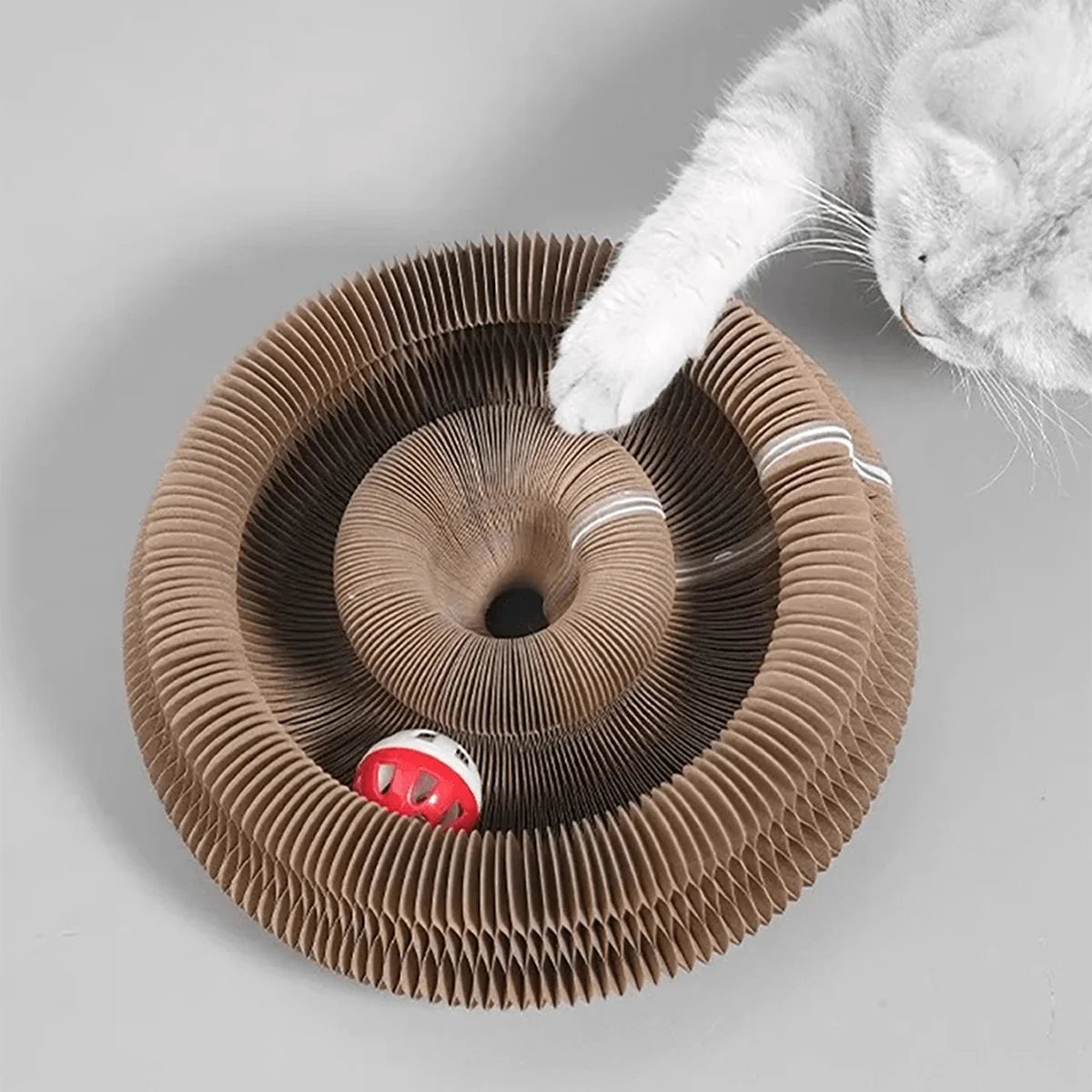 Scratch pad for cats featuring a catnip bell.